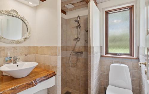 a bathroom with a sink and a shower at Nice Home In Asaa With Sauna in Aså