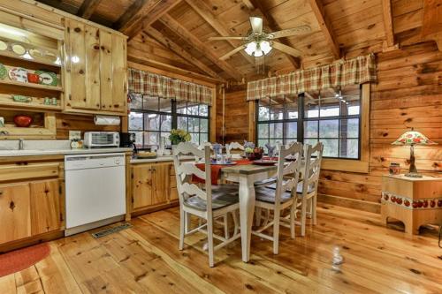 a kitchen with a table and chairs in a cabin at Living on the Ledge in Blue Ridge