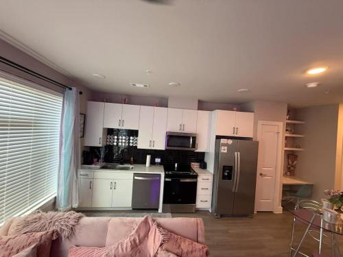 a kitchen with white cabinets and a stainless steel refrigerator at Pinky in Austin