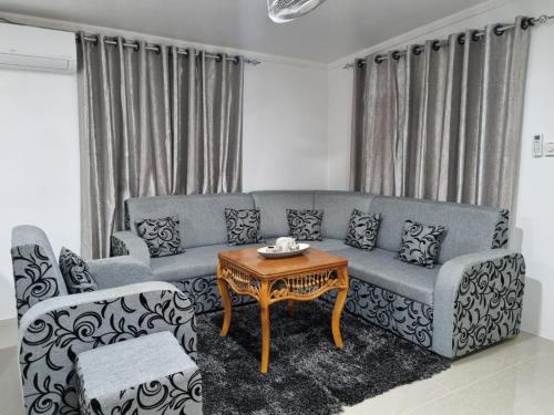 a living room with a couch and a table at Bula Breeze in Nadi