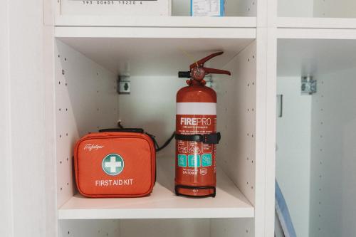 a fire extinguisher and a fire hydrant in a shelf at Private & Stylish Hinterland Cottage in Gold Coast