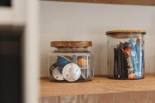 a jar of pens and other office supplies on a shelf at Private & Stylish Hinterland Cottage in Gold Coast