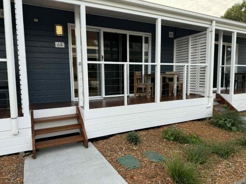 a screened in porch of a house with a bench at Ballina Beach Nature Resort in Ballina