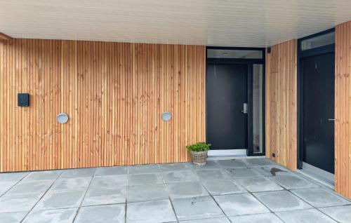 a building with a potted plant on the side of it at Cozy Home In Vestervig With Sauna in Vestervig