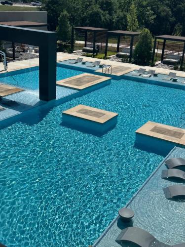 a swimming pool with blue water in a building at Pink Couture in Austin