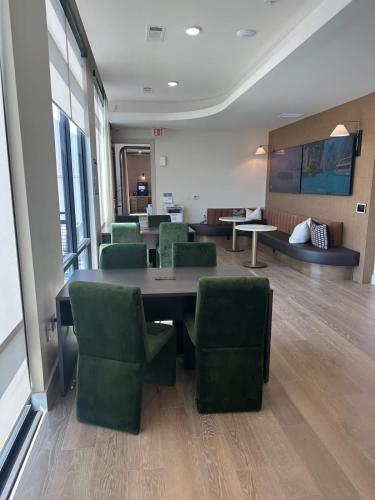 a waiting room with a table and green chairs at Pink Couture in Austin