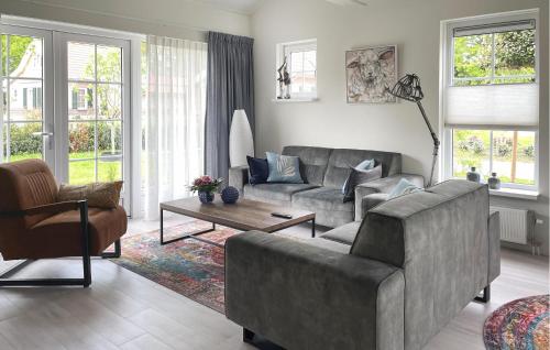 a living room with a couch and a table at Buitengoed Het Lageveld - 93 in Hoge-Hexel