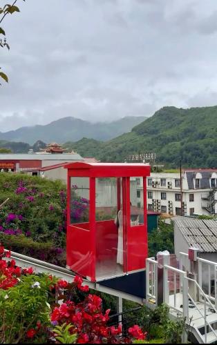 a red room on the roof of a building with flowers at Sapa Village Hotel in Sapa