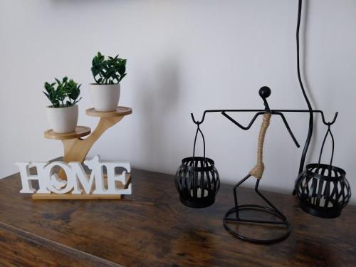 a table with two potted plants and a home sign at Bayay ni Lola in Mactan Cebu International