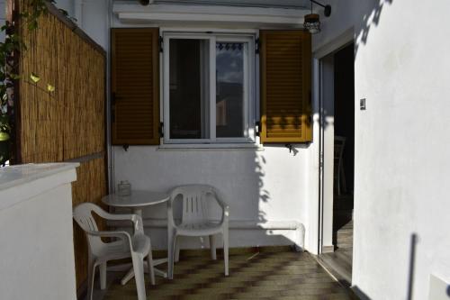 a table and chairs sitting on a patio at Porto Levante Anemos in Ermoupoli