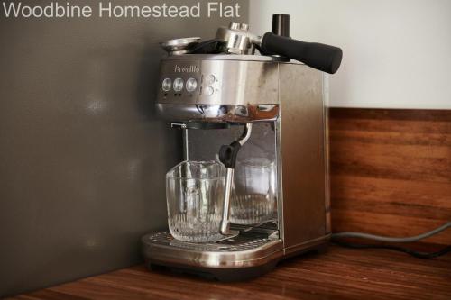 a blender sitting on a counter with a glass at Woodbine Homestead in Hallidays Point