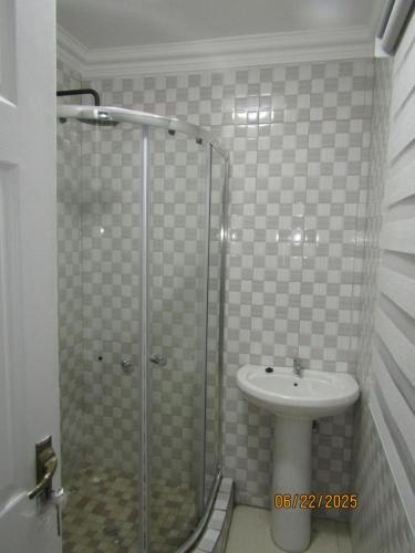 a bathroom with a shower and a sink at The PHOMOLONG GUEST HOUSE in Roodepoort