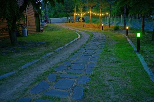 a cobblestone path in a park at night at Cheongju Crepas Pension in Cheongju