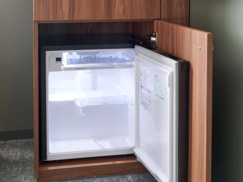 a refrigerator with its door open in a room at CROSS Life Hakata Tenjin in Fukuoka