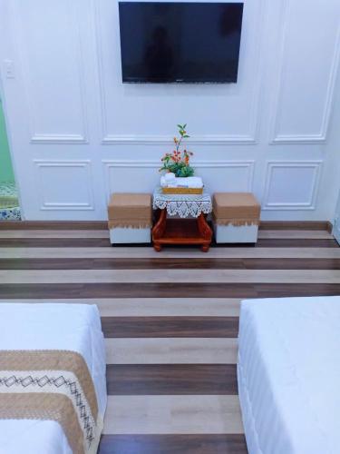 a room with three chairs and a table and a tv at Hoàng Nga 2 Homestay in Phan Thiet