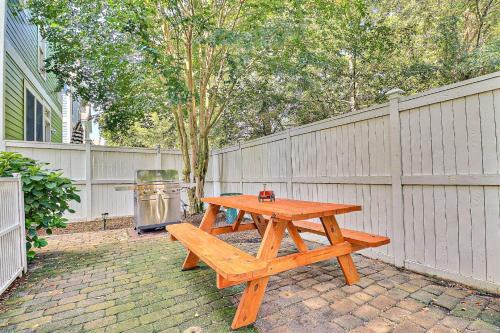 a wooden picnic table in a backyard with a fence at BB47 - A Wave From It All in Kill Devil Hills