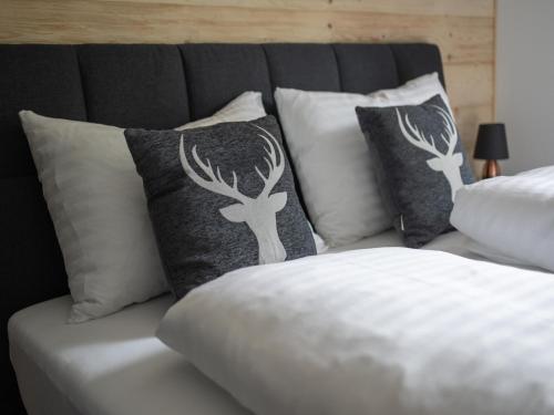 a white couch with pillows on top of it at Ski-in chalet with hot tub and sauna in Turracher Hohe