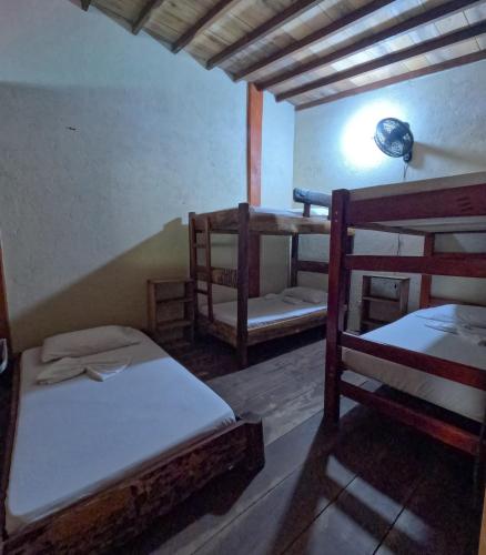 a room with two bunk beds and a lamp at Mi Cabaña El Maderal in Capurganá