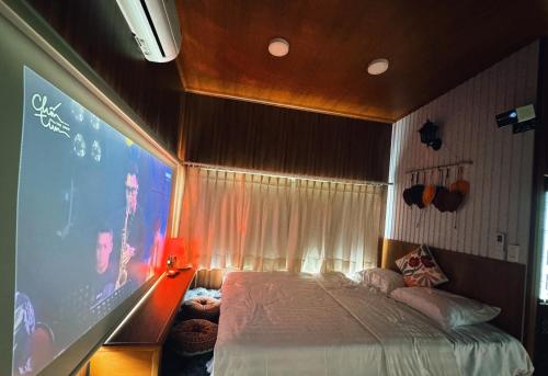 a bedroom with a large screen with a bed at B tree Retreat homestay in Thôn Dương Phẩm