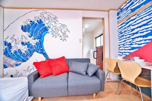 a room with a couch and a painting of a wave at BMO102A Direct bus to Disney from next station Max5 in Tokyo