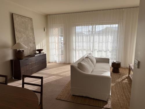 a living room with a white couch in front of a window at Interior Stylist's Country Unit in Nhill