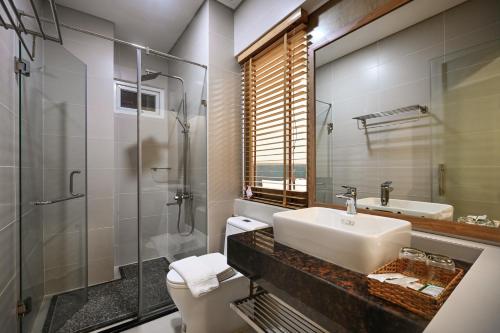 a bathroom with a sink and a toilet and a shower at Sunshine Airport Hotel in Ho Chi Minh City