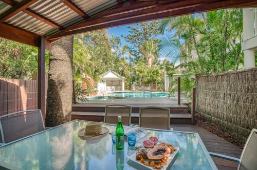 a table with a plate of food and a bottle of wine at The Lookout Resort Noosa in Noosa Heads