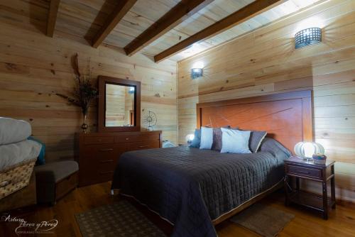 a bedroom with a bed in a wooden cabin at Cabaña Roble - Cabañas Terrazul in Pinal de Amoles