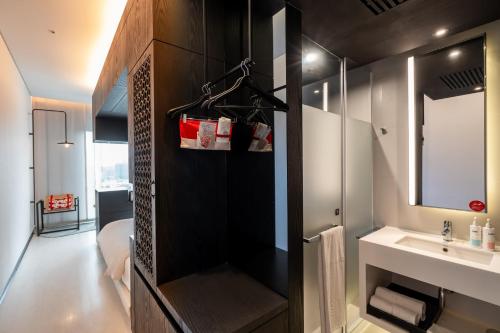 a bathroom with a sink and a mirror at The Place Tainan in Tainan