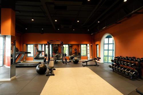 a gym with weights and exercise equipment in a room at Wonderland Royal Mansions Ho Tram in Xuyên Mộc