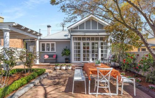 a home with a patio with a table and chairs at Clinton Charm - Stunning Heritage Home near CBD in Orange