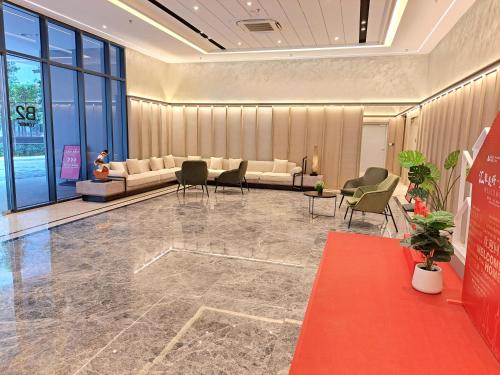 a lobby with a waiting room with couches and chairs at Bintang Family suite at Agile TRX by KL in Kuala Lumpur