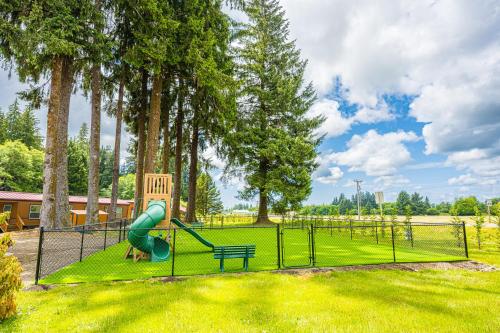a playground with a slide and a bench in a park at Rainforest Tiny Home Retreat #30 in Forks
