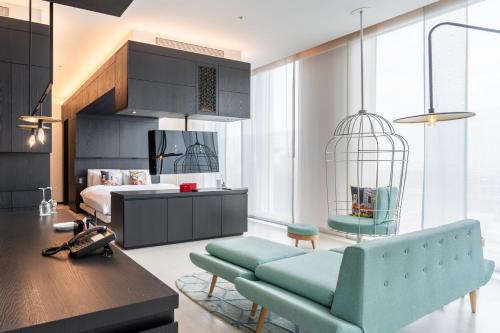 a living room with a couch and a bed at The Place Tainan in Tainan