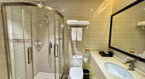 a bathroom with a shower and a toilet and a sink at Auspicious Hotel in Zhongshan