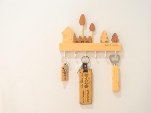 a wooden shelf with keys and a house on it at Cana Garden Minimal 4 in Satun