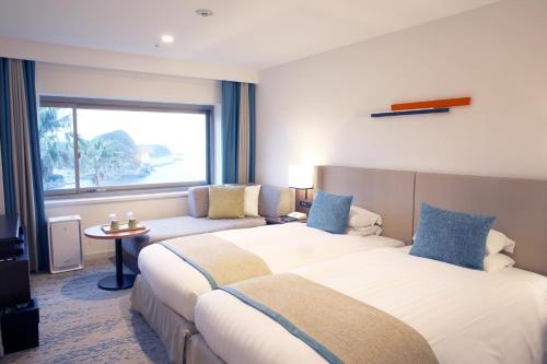 Postel nebo postele na pokoji v ubytování Shimoda Tokyu Hotel