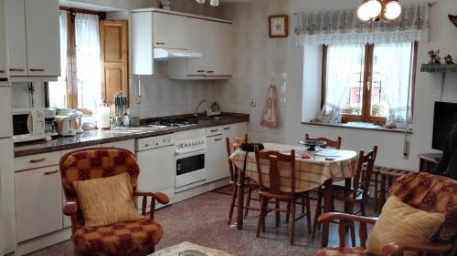a kitchen with a table and chairs and a dining room at La Casina de Llanes in Llanes