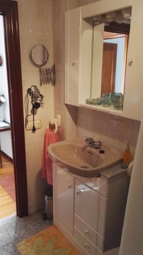 a bathroom with a sink and a mirror at La Casina de Llanes in Llanes