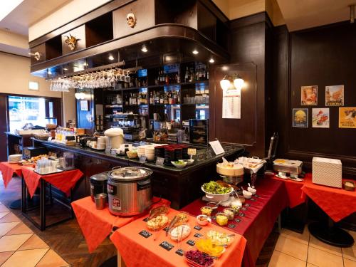a restaurant with two tables and a counter with food at APA Hotel Akasaka Mitsuke in Tokyo