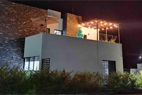 a building with lights on top of it at night at Casa de Campo Lake Shore Jocotepec in San Cristóbal Zapotitlán