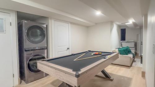 a pool table in a living room with a washer and dryer at Highend Hideaway Duplex with 1 FREE Parking, backyard and deck, pool table, 2 Kings plus 2 Baths, Sleeps 10, 2 Floors! 20 PERCENT OFF in Hoboken