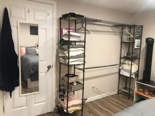 a room with a closet with a bed at Dolly's Deluxe Suite in Fort Saskatchewan