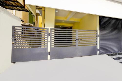 a metal gate in front of a house at Hotel O Eswar Residency Avadi in Chennai
