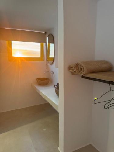 a bathroom with a sink and a mirror at Antiparos Gems in Agios Georgios