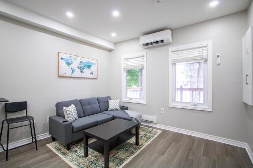 a living room with a couch and a table at Cozy Downtown London 1BR Gem in London
