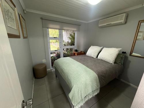 a bedroom with a large bed and a window at Cozy at Cedarwood in Oakdale