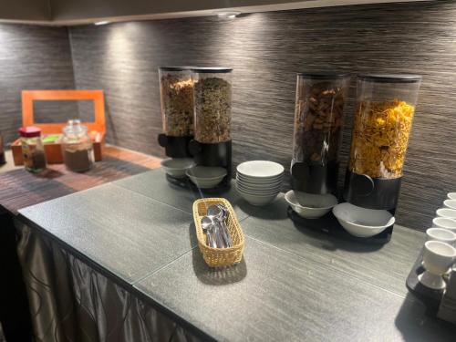 a table with three containers of food and a basket at Hotel Kiez Pension Berlin in Berlin
