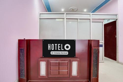 a hotel sign sitting on top of a red door at Hotel O Behror in Neemrana