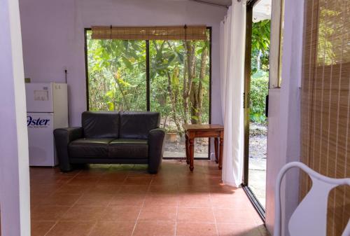 a living room with a couch and a window at Casa Lulú in Talamanca